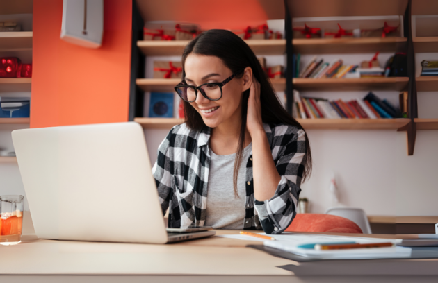 Woman working on her computer exploring revenue streams for rehab practice."