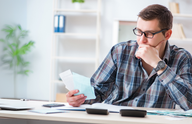 A man reviewing tax deduction documents at his desk