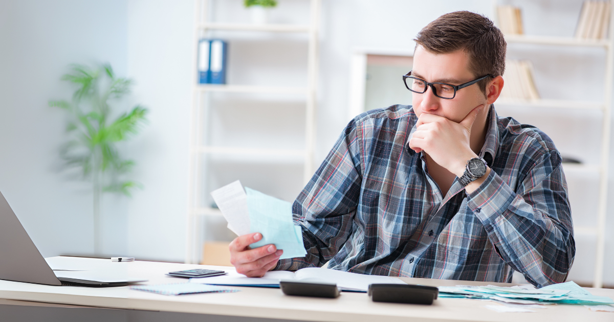 A man reviewing tax deduction documents at his desk