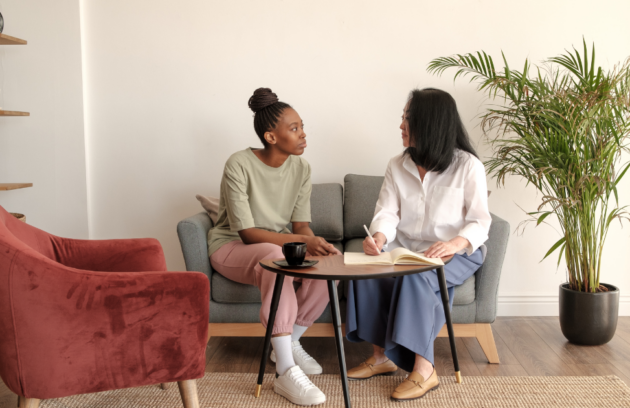 A therapist discussing a maintenance therapy plan with a patient during a follow-up visit to ensure continued functional independence and safety.