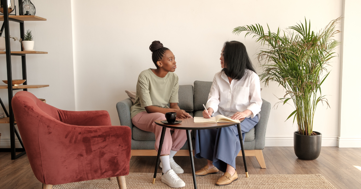 A therapist discussing a maintenance therapy plan with a patient during a follow-up visit to ensure continued functional independence and safety.