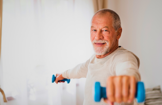 An elderly man performing a home exercise program, showcasing commitment to therapy goals in a home setting