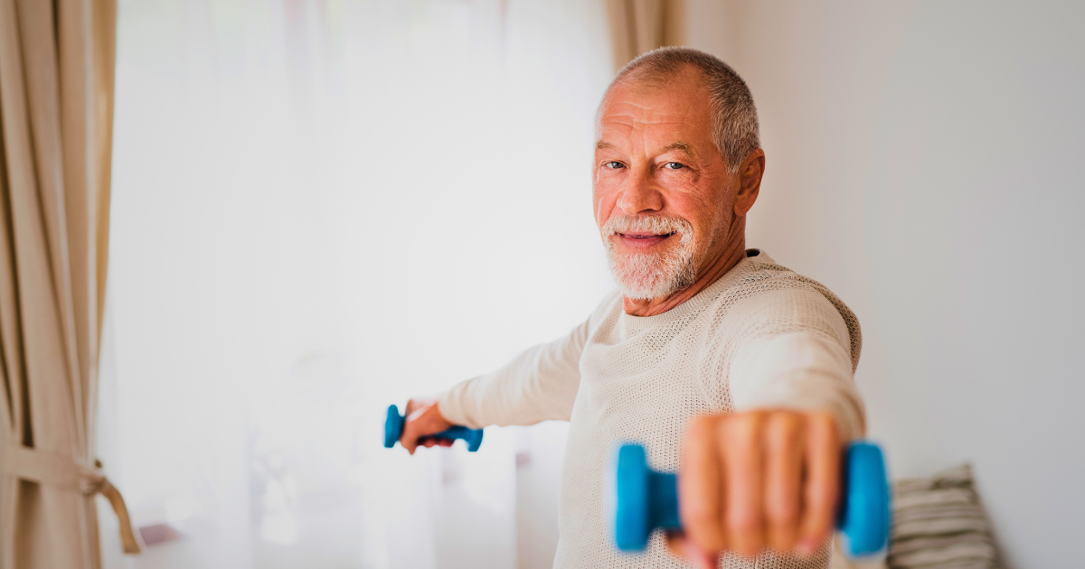 An elderly man performing a home exercise program, showcasing commitment to therapy goals in a home setting