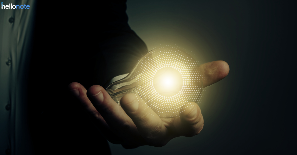 A hand holding a glowing lightbulb, symbolizing creative ideas and innovation for growth in therapy clinics. The background is dark, highlighting the importance of new strategies for clinic expansion and success.