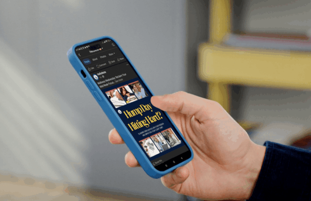 A hand holding a smartphone displaying a HelloNote Facebook Business Page, showcasing engaging content and social media interaction for a rehabilitation therapy clinic.