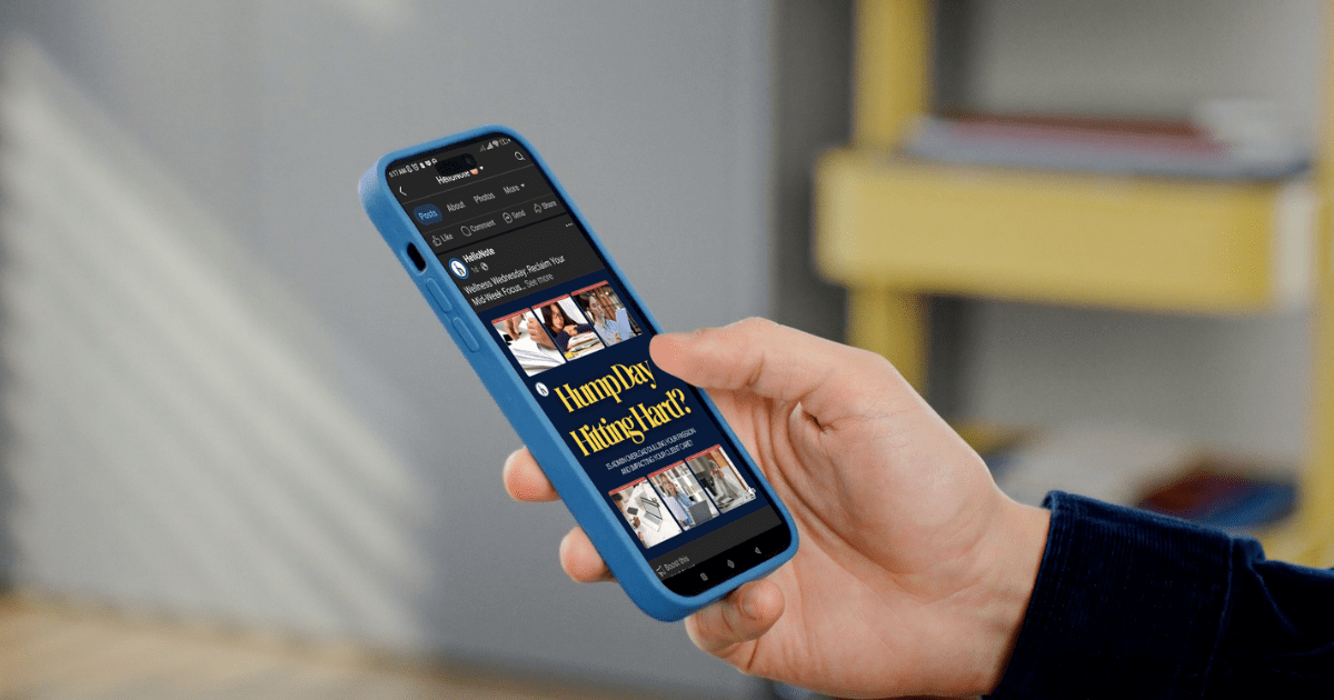 A hand holding a smartphone displaying a HelloNote Facebook Business Page, showcasing engaging content and social media interaction for a rehabilitation therapy clinic.
